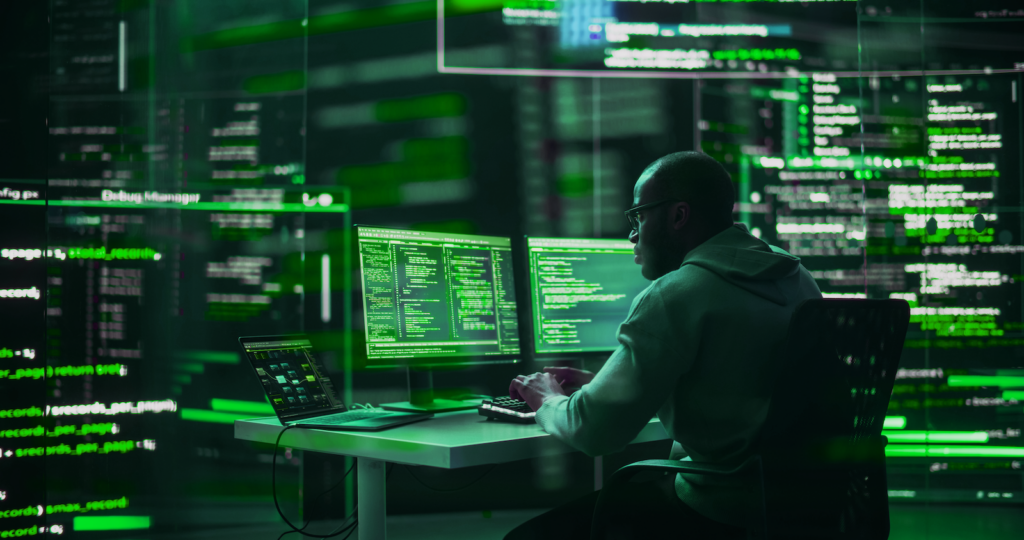 What is MDR? Image of man in security operations center looking at code.